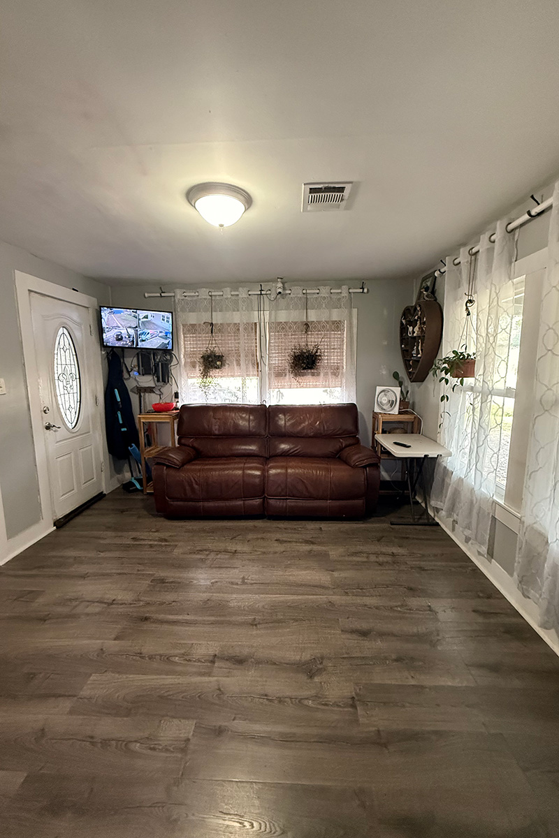 Living room with outdated furnishings before enhancement