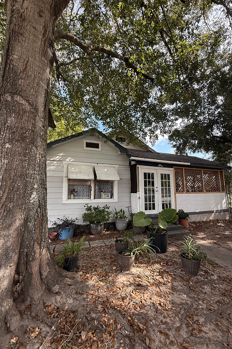 Front exterior with flat lawn and sky before enhancement